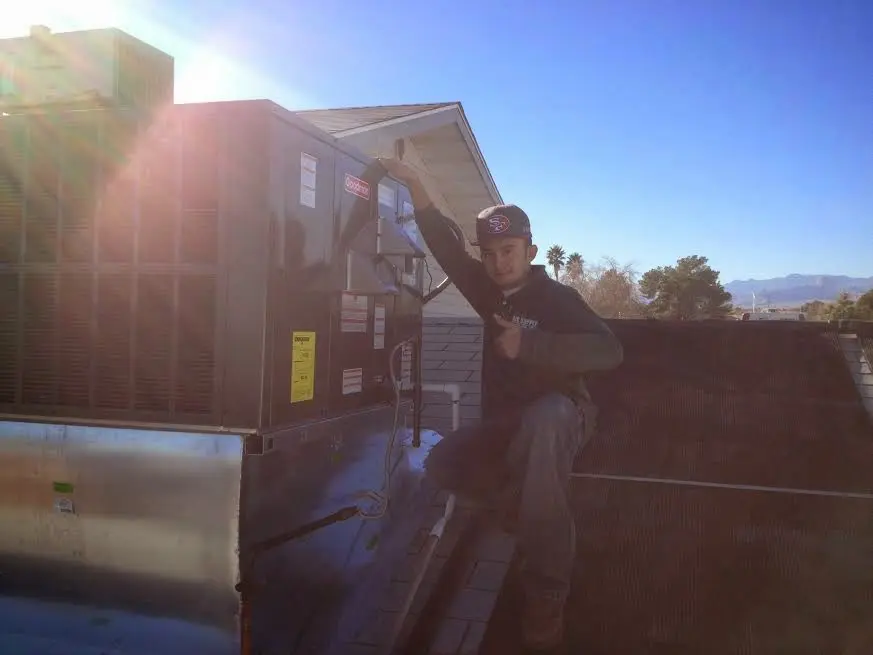HVAC technician performing HVAC Inspection on a rooftop unit in Chino Hills